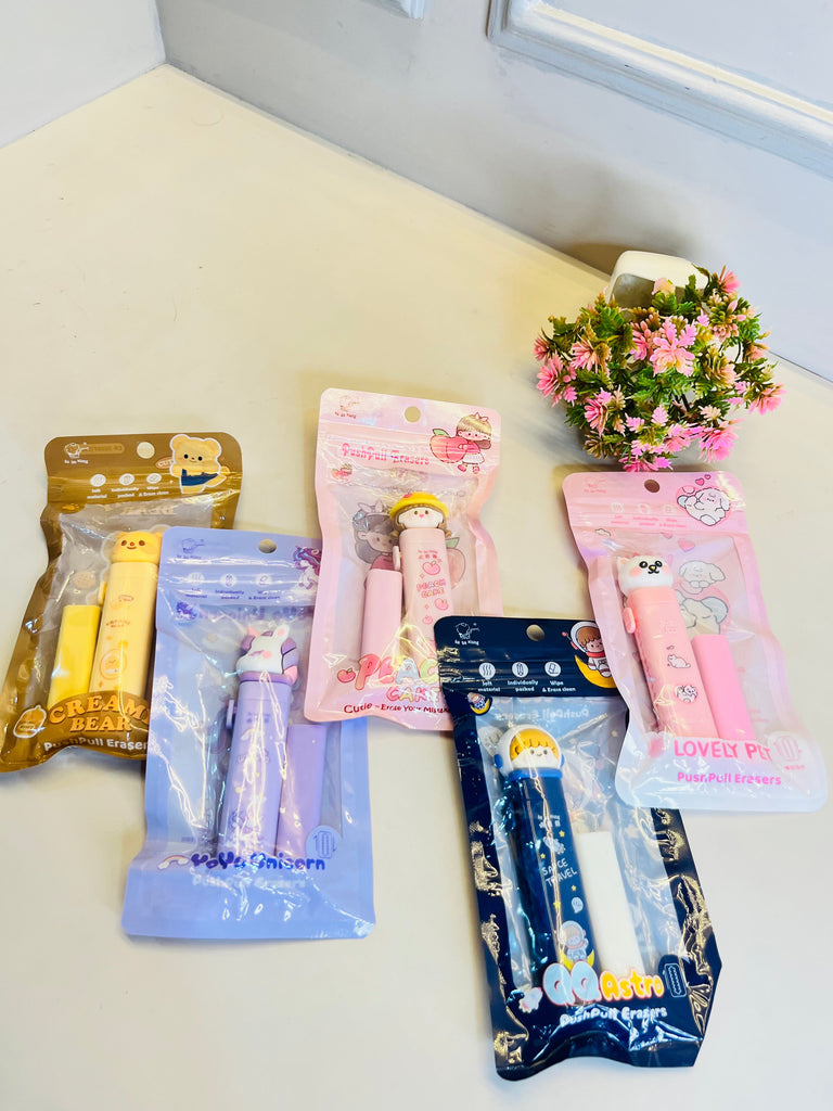 Collection of small packages with cartoon characters on a white surface with a plant in the background