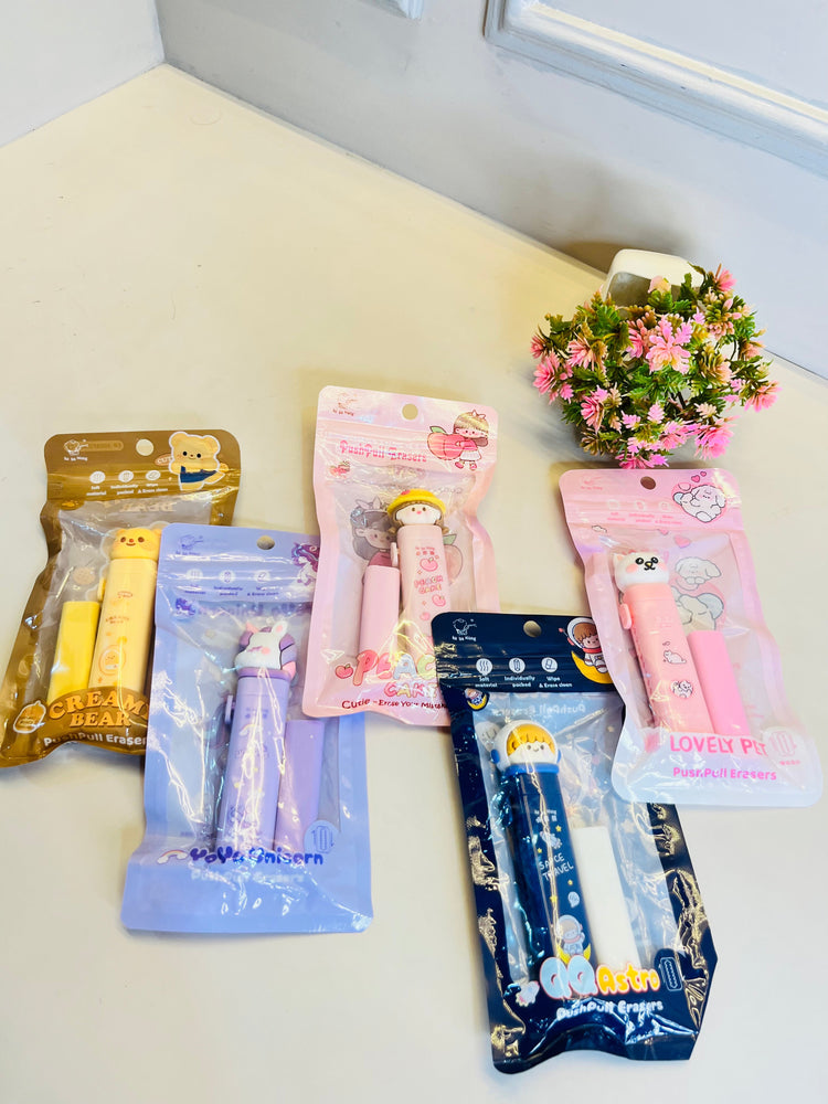 Collection of small packages with cartoon characters on a white surface with a plant in the background